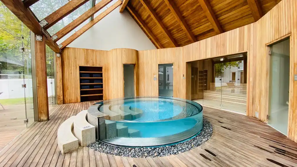 Serene indoor spa architecture with warm wooden arches and circular pools