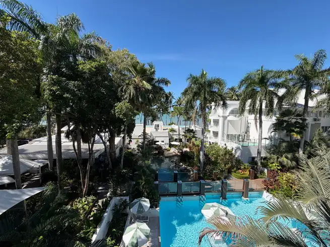 Aerial view of Quendario Grand Haven resort with tropical pool and ocean horizon